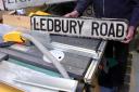 Repairing streets signs – and saving the taxpayer cash – are Tony Archer, Councillor Jim Kenyon and Mel Russell. Picture by James Maggs.