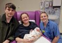Babies born on New Year's Day 2023 at Hereford County Hospital: Lily was born at 10.40am, pictured with mum Zoe Harries, dad Declan Collins and midwife Vic