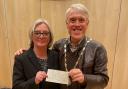 Caroline Warrey presents a cheque to Ledbury mayor Phillip Howells
