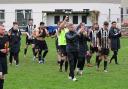 Ledbury Town players led by manager Ian Merrick applaud fans after their 3-0 victory