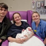 Babies born on New Year's Day 2023 at Hereford County Hospital: Lily was born at 10.40am, pictured with mum Zoe Harries, dad Declan Collins and midwife Vic