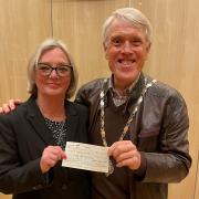 Caroline Warrey presents a cheque to Ledbury mayor Phillip Howells