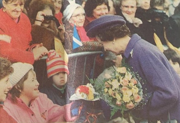 The Queen accepts flowers during a visit to Hereford in the 1990s