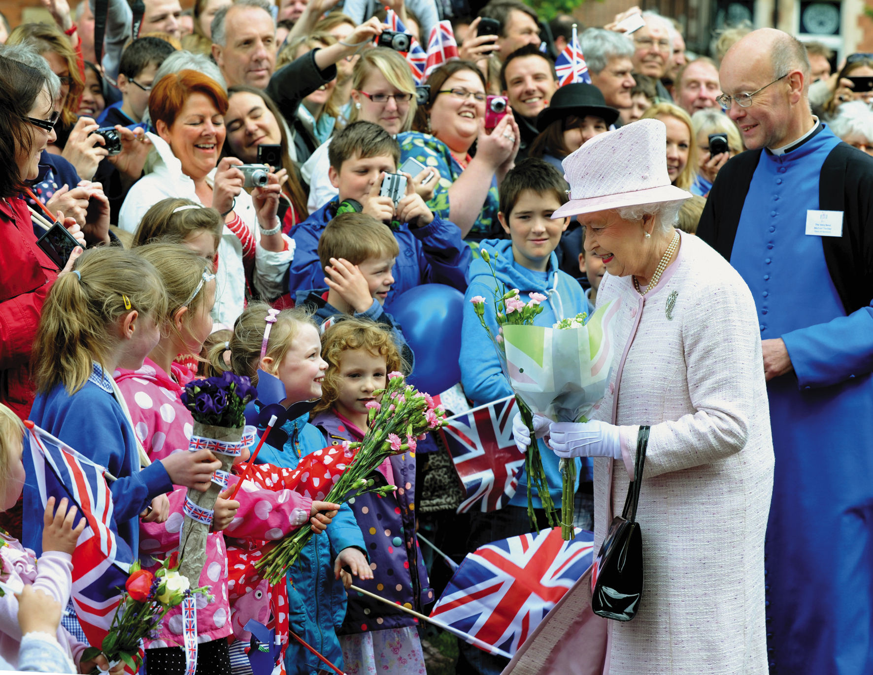 Queen Elizabeth II & Prince Philip visit to Hereford as part of her diamond jubilee tour, 2012. The Queen accepts bouquets of flowers from youngsters at Hereford Cathedral yesterday (Wed)...Photo Chas Breton..