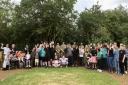 Children and teachers celebrate the refurbishment of the memorial garden