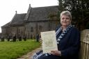Pictured is Diana Thomas outside Kilpeck Church with her new book.