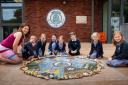 Children from across the years at Clyro CIW Primary School, Griff Lloyd, Chloe Jones, Fleur Jones, Alice Allen, William Glasspool, Poppy Brown and Ivy Davies pictured with headteacher Sarah Groves and the school’s new values mosaic. Photo: Billie Charit