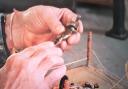 Repair Shop - pewter boxong figures being examined before repair.