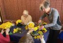 Chris Lynch helps the ladies make floral easter chicks