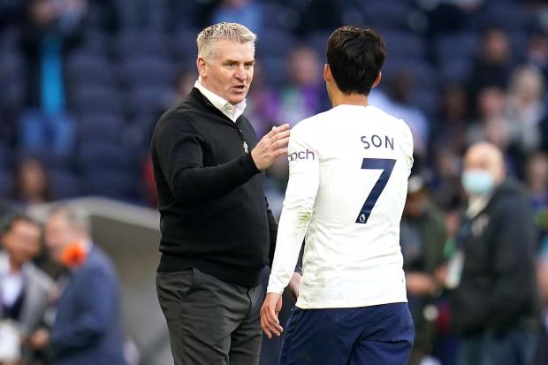 Dean Smith (left) shakes hands with Tottenham’s Son Heung-min