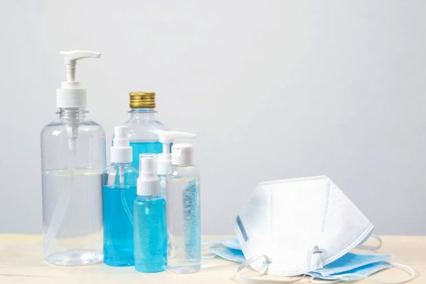 Ledbury Reporter: Bottles of hand sanitiser and face masks on a table (Canva)