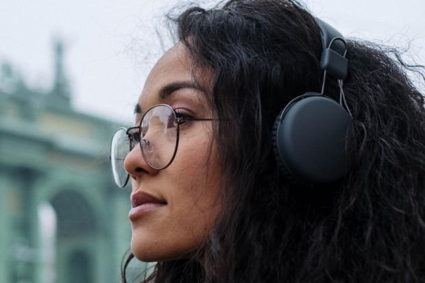 A woman listening to music. Credit: Canva