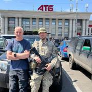 Ian Jackson (left) delivered a Land Rover to the Ukrainian military