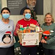 Store manager Helen Ward and optical assistants Navvh Gill and Kerry Davis with the hamper prize