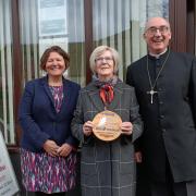 Cllr Ellie Chowns, church steward Janet Searle and Rev Graham Thompson with the new plaque
