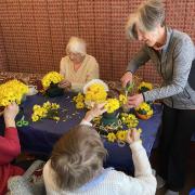 Chris Lynch helps the ladies make floral easter chicks